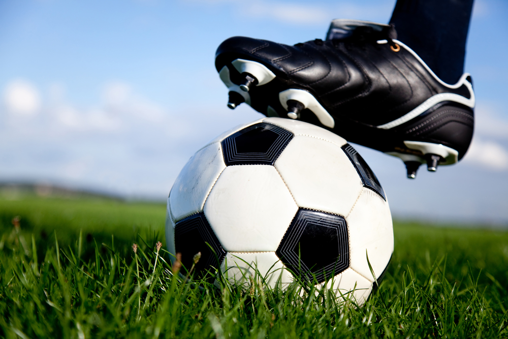Football or soccer ball at the kickoff of a game - outdoors Football or soccer ball at the kickoff of a game - outdoors