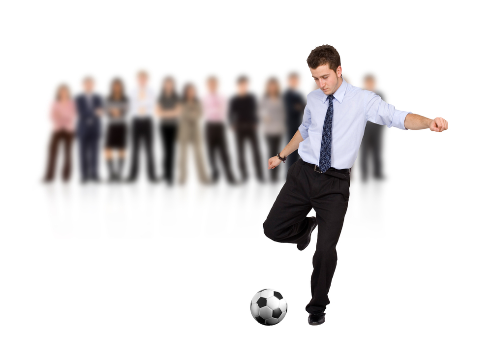 business man with a football and a group isolated over a white background